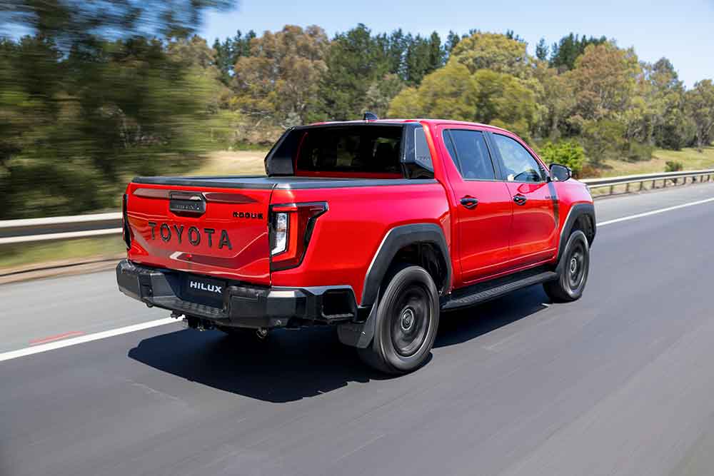 Toyota HiLux Rogue side view on the highway.