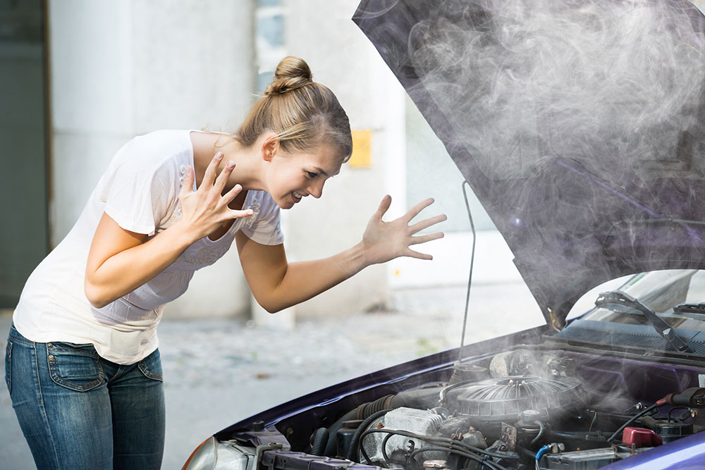 Woman with overheated car engine.