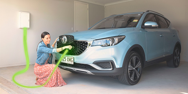 woman charging electric car with green energy 
