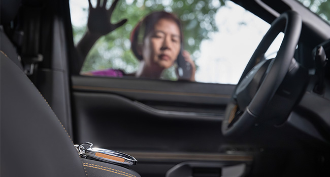 woman on the phone with keys locked in car 600x350